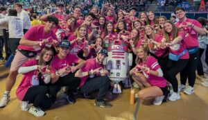 R2-KT visits Penn State surrounded lots of people wearing pink shirts