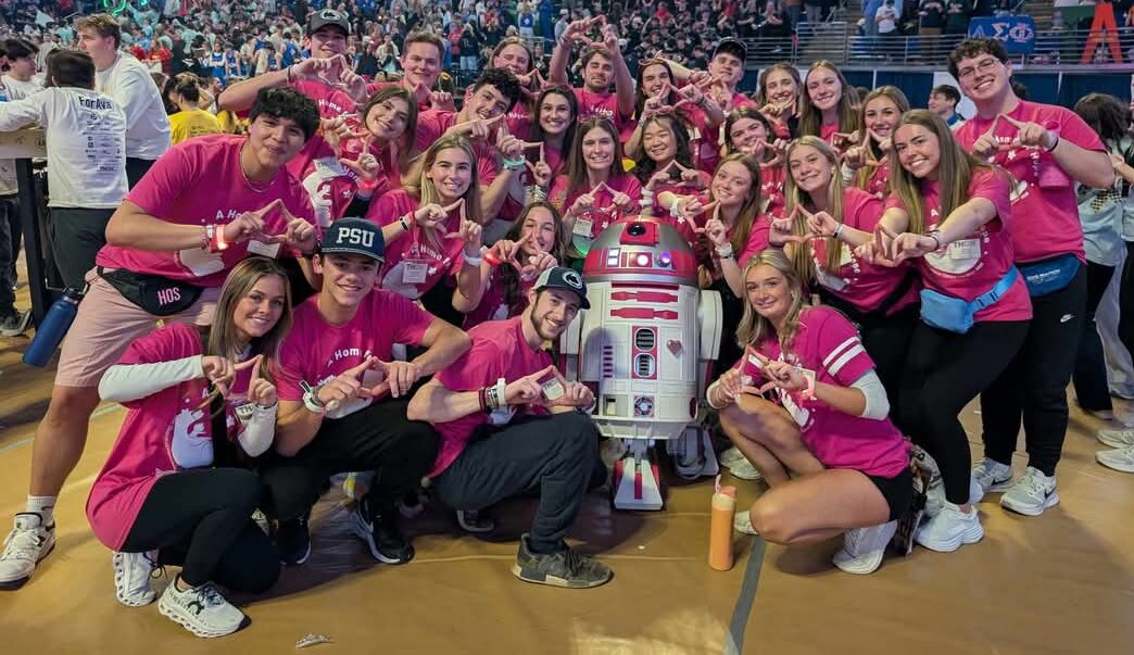 R2-KT visits Penn State surrounded lots of people wearing pink shirts